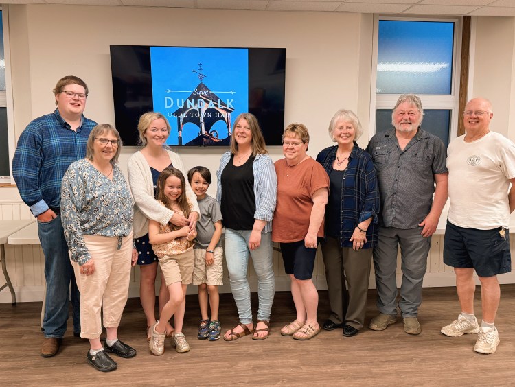 Dundalk Team Town Hall board members gather with friends and children together for a group photo smiling at the camera