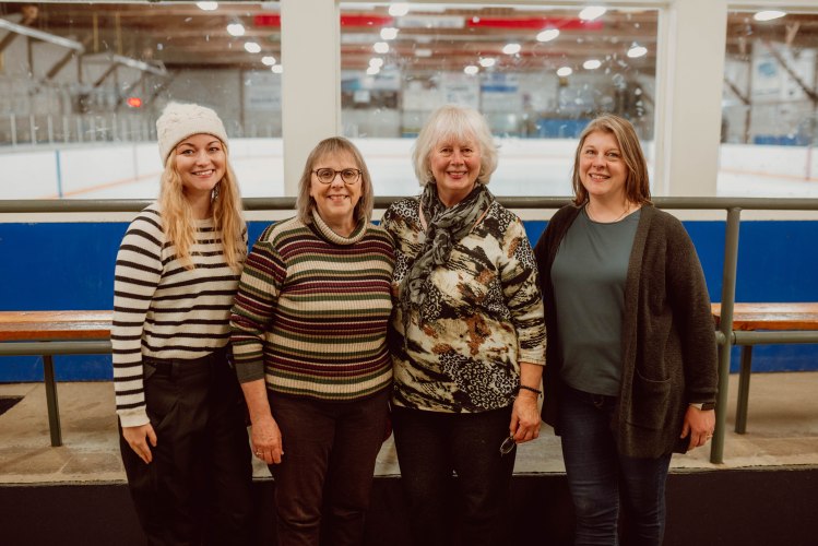 Team Town Hall board members gather for a group photo smiling at the camera at the Dundalk Arena during the free skate event